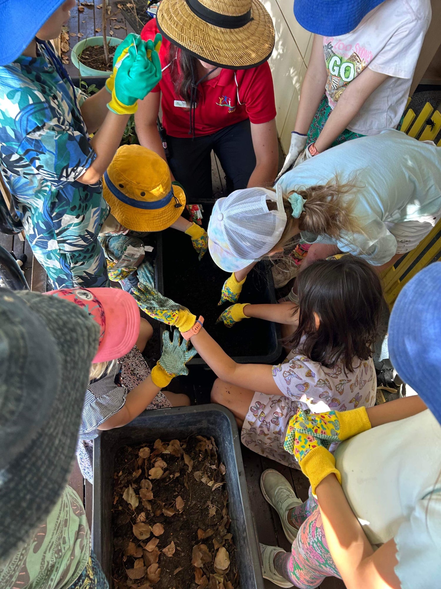 Sabrina Guse when she worked at Bulimba Outside School Hours Care, teaching students how to garden.